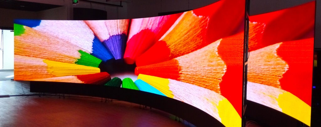 Curved video wall displaying a vibrant colored pencils image for the home.